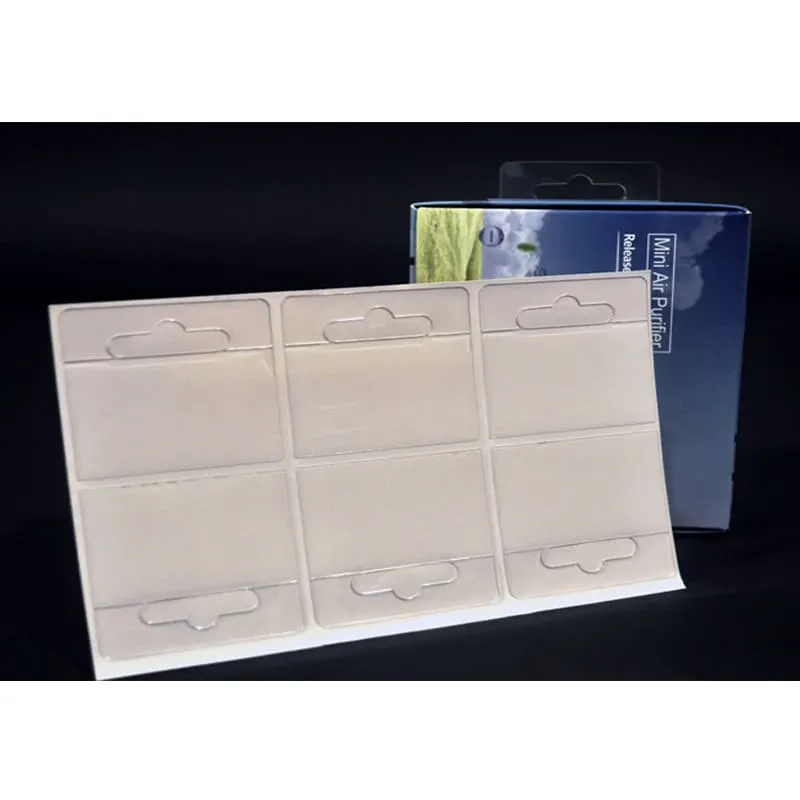 Six clear adhesive hang tabs arranged on a single release sheet for bulk retail packaging.