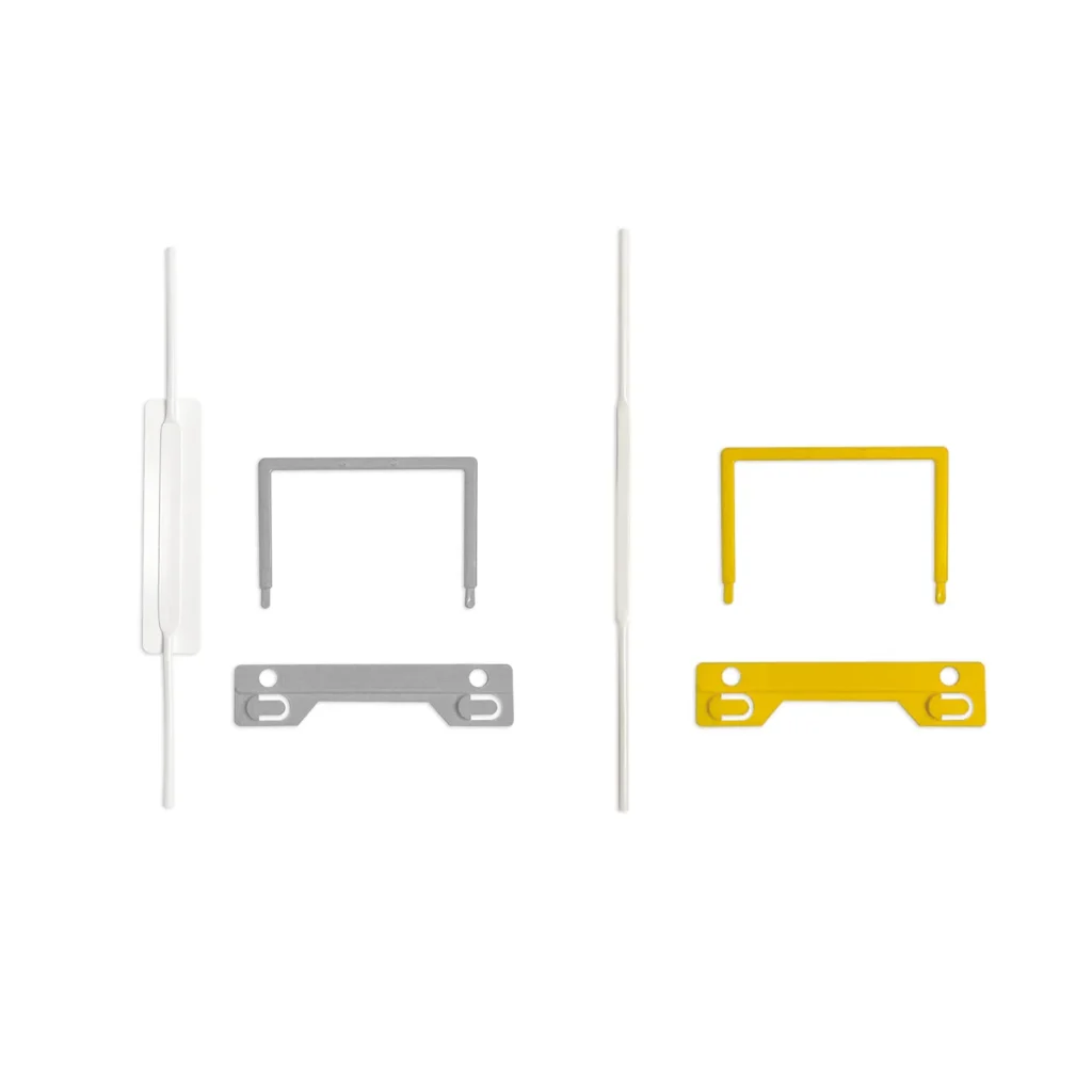 Plastic tube file fastener components showing grey U-clip with self-adhesive tube and yellow U-clip with non-adhesive tube, for document binding applications.